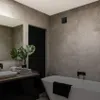 A modern bathroom with a bathtub, sink, and vanity. Anteprima dell’immagine prodotto