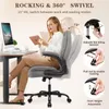 A woman is sitting in a gray office chair at a desk with a computer, demonstrating the chair's features. Voir les images du produit