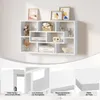 A white wall-mounted shelf unit with various decorative items and books, shown with close-up details of its features. Produktbild-Vorschau