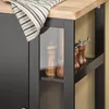A close-up view of a kitchen cart with a striped cloth draped over the top, showing salt and pepper grinders on a shelf. Produktbild-Vorschau