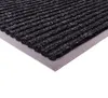 Close-up of a doormat with a ribbed texture and a metallic edge. Anteprima dell’immagine prodotto