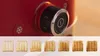Close-up of a red toaster's control dial and a row of toast slices showing different levels of browning. Voir les images du produit