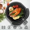 A cooked salmon fillet with asparagus, tomatoes, and lemon slices inside an air fryer basket, surrounded by ingredients and icons representing product features. Podgląd zdjęcia produktu
