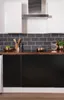 A modern kitchen counter with black cabinets and copper accents. Produktbild-Vorschau