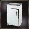 A white sink cabinet with a partially open door and a silver handle, set against a black background with a decorative border. Náhľad obrázku produktu