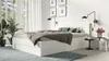A white bed frame with a mattress and bedding in a bedroom setting. Náhled obrázku produktu