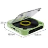 A green portable CD player with its lid open, showing a vinyl record inside. Dimensions are indicated with measurement lines. Produktbild-Vorschau