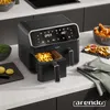 A black Arendo XXL dual-chamber air fryer is shown on a kitchen counter, filled with french fries in one of its chambers. Other food items like fried chicken and potato wedges are visible in bowls and on a slate plate nearby. Produktbild-Vorschau