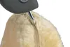 A close-up view of a car seat cover made of sheepskin, attached to a headrest. Produktbild-Vorschau