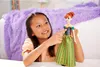 A young girl is playing with a doll in a bedroom. Náhled obrázku produktu