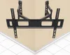 A black TV wall mount is shown mounted on a wall, with a white tiled floor and baseboard visible at the bottom. Produktbild-Vorschau
