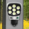 Weiße und schwarze Solar-Bewegungsmelderleuchte mit sieben LED-Lampen, montiert an einem grauen Pfosten im Freien Voir les images du produit