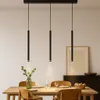 A dining table set with chairs and a pendant light fixture above. Produktbild-Vorschau