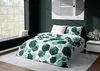 A bedroom scene with a bed dressed in green patterned bedding, a large window, and artwork on the wall. Podgląd zdjęcia produktu