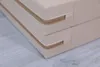 A close-up view of a beige, two-part gymnastics mat with visible zippers. Náhled obrázku produktu