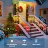A snowy house decorated with Christmas lights and decorations. Náhled obrázku produktu