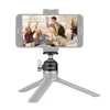 A smartphone is mounted on a mini tripod, displaying a group of people having fun. Produktbild-Vorschau
