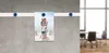 A family photo is attached to a magnetic strip on a textured wall, with a blurred office background. Produktbild-Vorschau