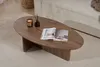 A walnut coffee table with a magazine, candle, and diffuser on it, placed on a rug next to a sofa. Anteprima dell’immagine prodotto