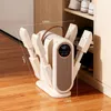 A shoe dryer is shown on a wooden floor next to a shoe cabinet. Produktbild-Vorschau