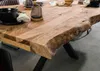 A close-up view of a wooden dining table with a live edge and black metal legs. Produktbild-Vorschau