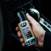 A hand holding a can of K2 Klima Fresh air conditioner refresher inside a car. Náhľad obrázku produktu