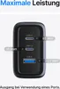 A close-up of a black USB charger with multiple ports, showing power output specifications. Produktbild-Vorschau