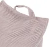 A close-up view of the textured fabric of a pink children's seat cushion with a handle. Produktbild-Vorschau