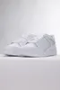 A pair of white Puma sneakers on a white surface. Produktbild-Vorschau
