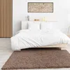 A bedroom with a bed and a rug. Produktbild-Vorschau