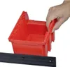 A hand is shown holding the edge of a red storage bin. Produktbild-Vorschau