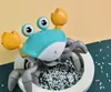 A close-up shot of a toy crab with its legs in a white circular base filled with small white pellets. Produktbild-Vorschau
