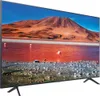 A television displaying a landscape image of a mountain and a pink flamingo in a red lake. Produktbild-Vorschau