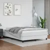 A white boxspring bed frame with a grey blanket is shown in a bedroom setting. Voir les images du produit