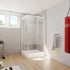 A bathroom with a shower cabin, punching bag, and weights. Produktbild-Vorschau