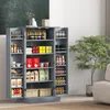 A grey pantry cabinet filled with various food items and containers, with a potted plant and a couch visible in the background. Anteprima dell’immagine prodotto