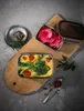 A rectangular food container with a frittata and sliced radishes, presented on a wooden board with a spoon and spices. Anteprima dell’immagine prodotto
