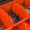 A close-up view of orange plastic storage bins filled with screws and other hardware. Produktbild-Vorschau