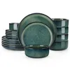 A set of green ceramic dishes, including plates and bowls, stacked and arranged on a white background. Náhled obrázku produktu