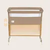 A baby crib/bassinet with mesh sides, shown against a plain background. There are graphic arrows on the left side indicating adjustability. Náhľad obrázku produktu