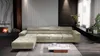 A modern living room with a large sectional sofa, fireplace, and decorative elements. Náhled obrázku produktu