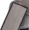 A person is holding a rectangular scratching mat with a textured surface and a dark gray furry border. Produktbild-Vorschau