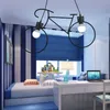 A child's bedroom with a bed, desk, and a bicycle-shaped pendant light. Podgląd zdjęcia produktu