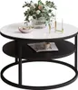 A round coffee table with a white top and black shelf, decorated with a vase of flowers, a bowl of candies, and a candle holder. Produktbild-Vorschau