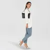A woman is posing with a black handbag. Produktbild-Vorschau