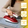 A person is using a red and white travel iron on a light gray ironing board. There are three yellow square icons on the right side of the image. Produktbild-Vorschau