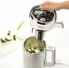A person is holding a Moulinex soup maker over a stainless steel pot filled with chopped zucchini. Produktbild-Vorschau