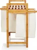A bamboo laundry basket with two fabric bags hanging from it, shown against a white background. Anteprima dell’immagine prodotto