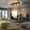 A modern living room with a sofa, ottoman, coffee table, and TV. Anteprima dell’immagine prodotto