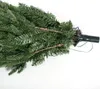 A close-up view of the bottom section of an artificial Christmas tree, showing the branches and the connection point to a stand. Náhľad obrázku produktu